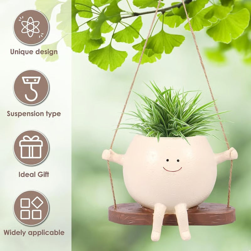 Hängender Pflanztopf mit lächelndem Gesicht